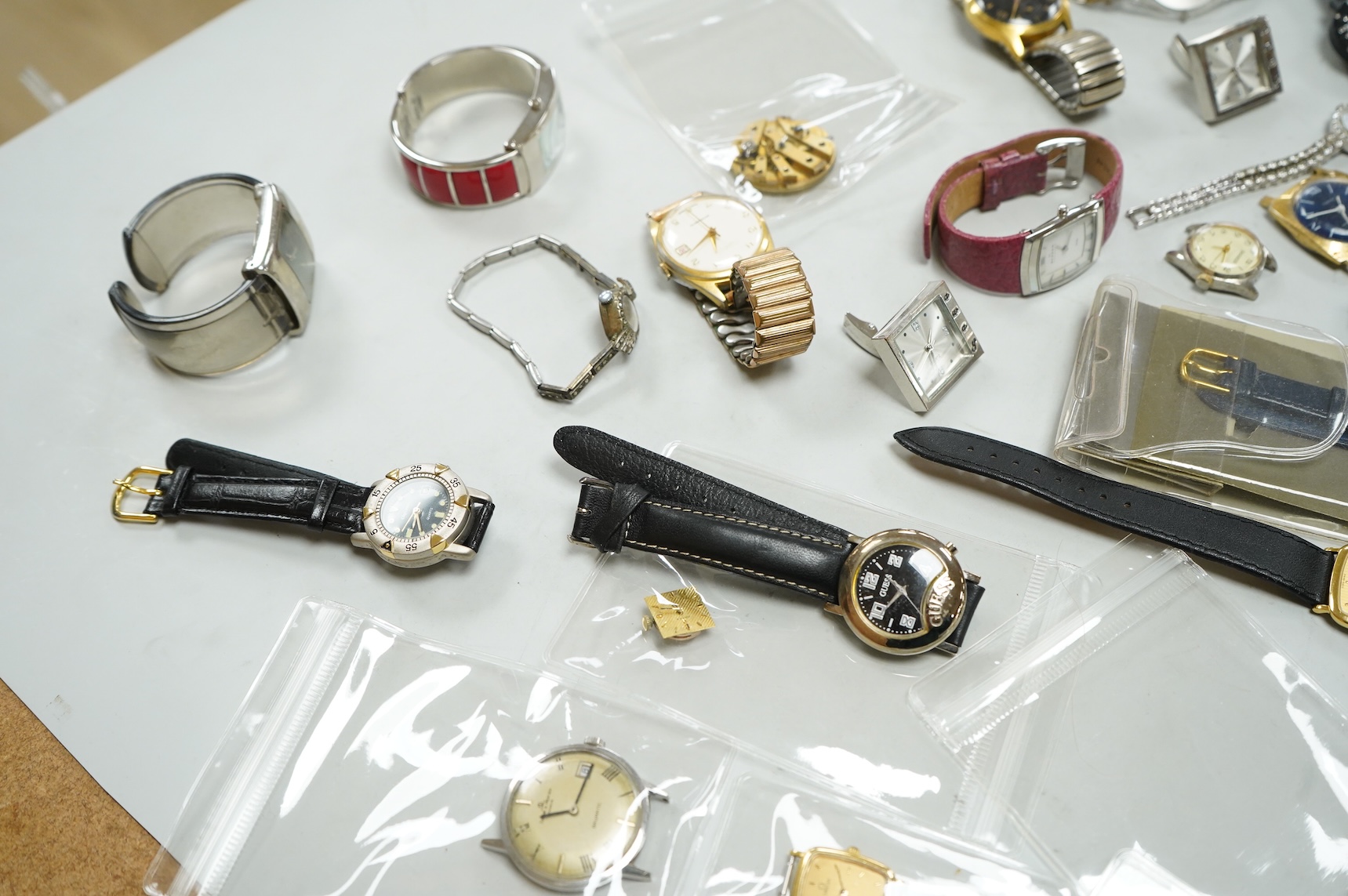 A small collection of assorted lady's and gentleman's wrist watches, including three Omega De Ville steel and gold plated quartz watches and wrist watches movements including Girard Perregaux.